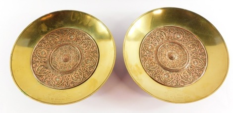 A pair of Victorian copper and brass dishes, with embossed Arabesque decoration, engraved to the rim 'Highgate School Pole Jump, W Maude 1881' 25cm diameter.