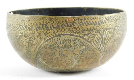 An Indian brass bowl, engraved with scrolls and birds, 9cm diameter.