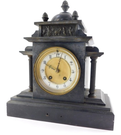 A 19thC black slate mantel clock, the brass circular brass dial with white enamel chapter ring bearing Arabic numerals, Hamburg American Clock company eight day movement with coil strike, the case of architectural form with a domed pediment, raised on flu