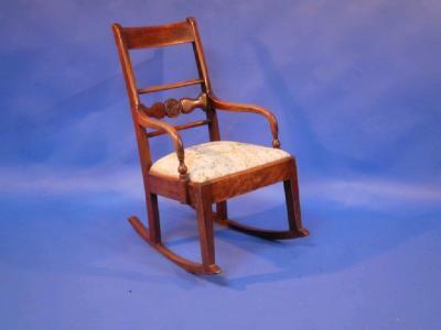 A 19thC mahogany rocking chair with drop-in upholstered seat