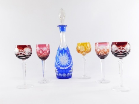 A continental blue flashed glass decanter and stopper, together with three flashed glass hock glasses, and two further wine glasses, the decanter 10cm high.