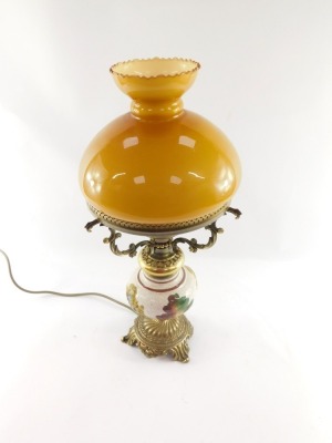 A 20thC oil lamp style electric table lamp, with orange glass shade on a brass three prong support, with glazed and floral print body on rococo foot, 52cm high. WARNING! This lot contains untested or unsafe electrical items. It is supplied for scrap or r - 3