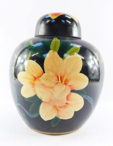 A 20thC Chinese Republic pottery ginger jar and cover, painted with orange flowers orange flowers and leaves against a black ground, printed mark, 27cm high.