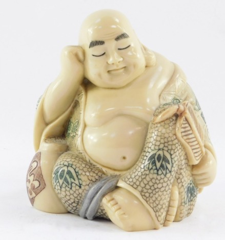 A resin figure of a seated Buddha, 11cm high.