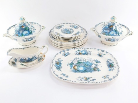 A Mason's ironstone part dinner service decorated in the Fruit Basket pattern, comprising two tureens and covers, a serving plate, gravy boat and saucer, five side plates and six dinner plates.