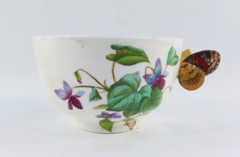 A late 19thC pottery breakfast cup, with butterfly handle, painted with violets, printed registration lozenge, 8cm high.