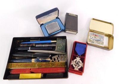 A Third Reich Civil Service Faithful Service Medal, Calibri lighter, a group of Parker and Waterman pens, sealing wax sticks, commemorative Berlin Aircraft stamp, etc.