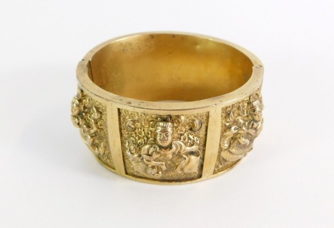 An Eastern hammered designed hinged bangle, each with panel depicting Greek goddess, on a gold coloured finish, white metal stamped 925, 7cm diameter, 81.3g all in, boxed.