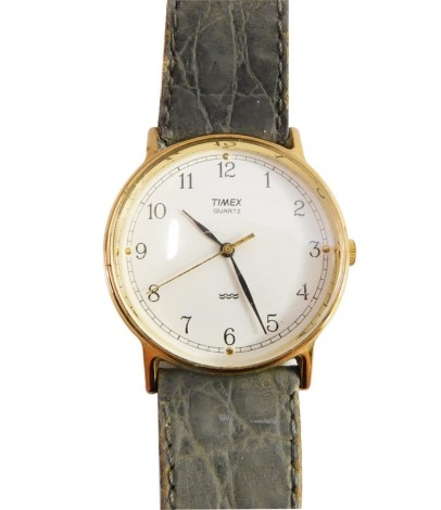 A Timex quartz gentleman's wristwatch, with gold plated outer case on a stainless steel back, with cream coloured dial, on a later leather strap, the watch head, 3cm diameter.