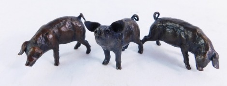 A set of three bronze models of pigs, in varying poses, limited edition 250, stamped MS, each approx 4cm wide.