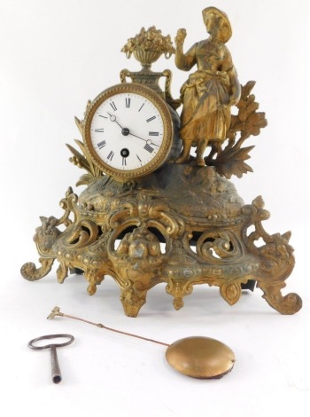 A French late 19thC gilt spelter mantel clock, circular enamel dial bearing Roman numerals, thirty hour movement, the barrel shaped case flanked by a female figure and flowers, on a rococo scroll base, with pendulum and key, 33cm high.