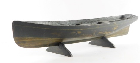 A scratch built wooden rowing boat, with painted hull, on stand, 47cm wide.