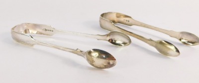 Two pairs of silver sugar tongs, comprising a George III pair, monogram engraved, London 1813, and a Victorian pair of plain design, Sheffield 1882, 2¾oz.