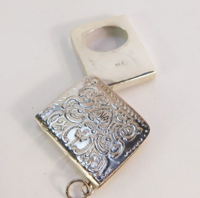 A silver stamp case, of book form, embossed 'Stamps' with floral scroll detailing, ring chain attachment, stamped 925, 3.5cm wide. - 3