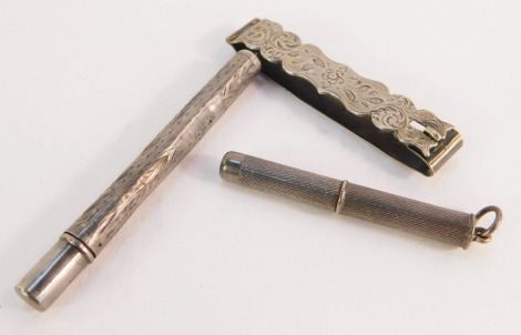 A silver propelling tooth pick, with engine turned decoration, Birmingham 1952, a white metal money clip, and a silver cased pencil with engraved decoration, 15g. (3)