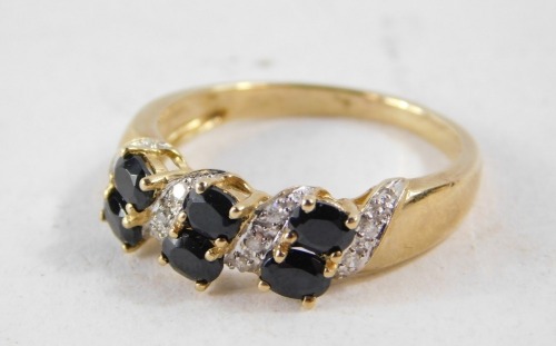 A 9ct gold dress ring, set with imitation diamond and sapphire stones, in crossover claw setting, size P½, 3g all in.