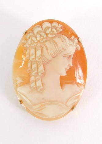 A shell cameo brooch, depicting maiden in high relief, in a yellow metal frame marked 9ct, 6.7g all in, 4cm x 3cm.