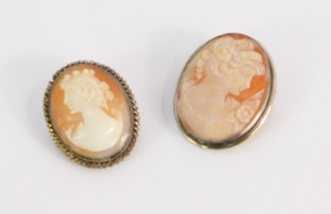 Two vintage shell cameo brooches, each with silver frames.