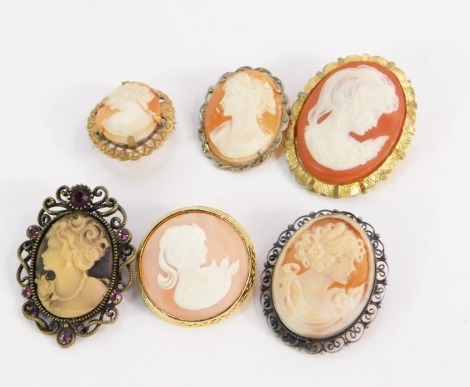 A group of cameo pendants and brooches, one with Edwardian design in a silver frame, other plated examples, one with marcasite border. (6)