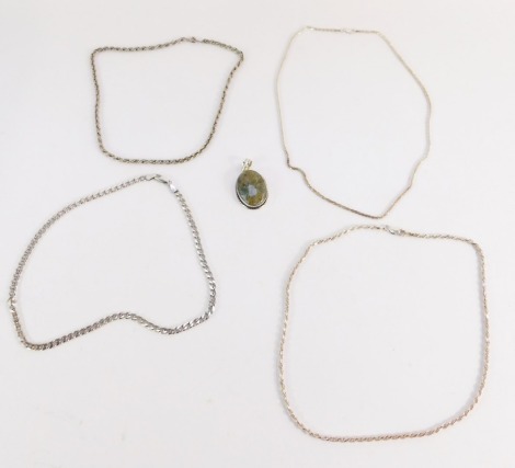 A group of silver jewellery, to include four various silver chains, and a stone set pendant. (5)