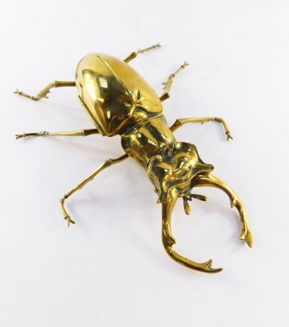 A 19thC brass stag beetle desk stand, the top of the body hinged to reveal an ink well and recess, 35cm long.