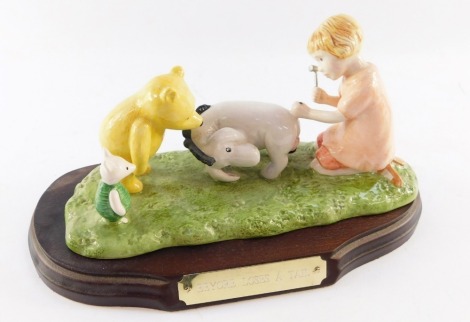 A Royal Doulton The Winnie The Pooh Collection figure group Eeyore Loses a Tail, collector's figure, WP15, limited edition no 1545/5000, on wooden base, 22cm wide, boxed.