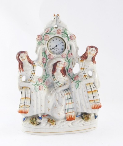 A Staffordshire late 19thC flat back figural pocket watch holder, depicting three maidens, holding a silver plated pocket watch, 30cm high.