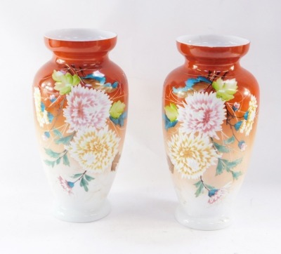 A pair of late 19thC white glass vases, of shouldered, tapering form, painted with flowers against a rust red ground, 34cm high. (2)