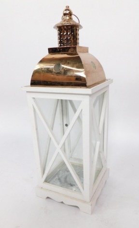 A modern lantern, with hammered copper effect top, on painted white paneled box base, 64cm high.