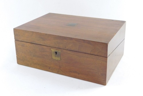 A Victorian mahogany writing box, with brass crest and key escutcheons, opening to reveal a fitted interior, with black leather inset slope, 12cm high, 30cm wide, 22cm deep.