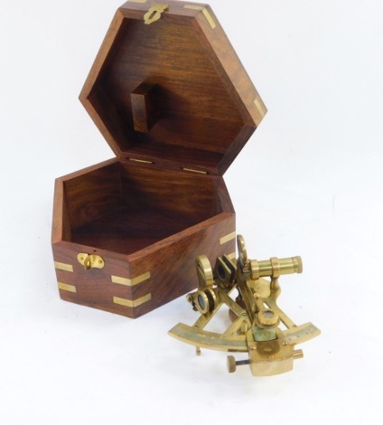 Nautical Interest. A brass sextant, in a wooden fitted case, with brass bound detailing and anchor.