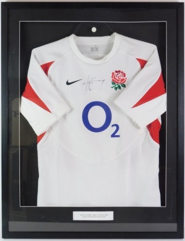 An England, British and Irish Lions football shirt, bearing signature for Martin Corey MBE captain of Leicester Tigers, in modern frame with presentation plaque, no available provenance.