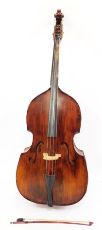 A Boosey & Hawkes Double Strad double bass, 3/4 size, with a bow.