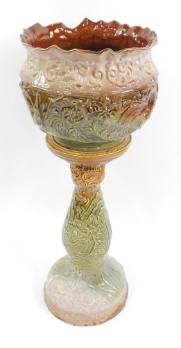 A Wood Rhydding green and brown pottery jardiniere and stand, with floral and leaf moulded decoration, impressed mark, 80cm high, 31cm diameter.