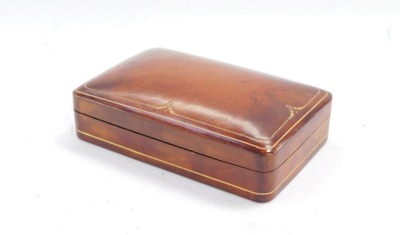 A leather and gilt tooled finish cuff links box, 14cm wide.