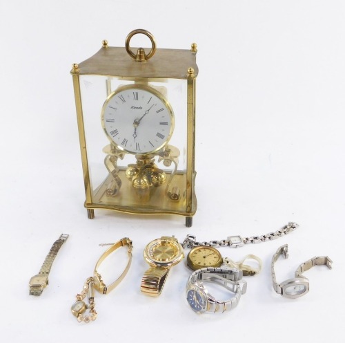 A Kundo brass cased anniversary clock, with wave design top, and silvered coloured dial, three point ball end, 22cm high, 14cm wide, 10cm deep.