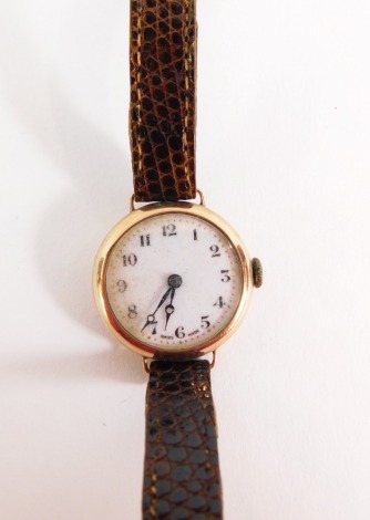 A lady's 9ct gold wristwatch, with circular wristwatch head on white enamel dial, with gold outer counters and blue hands, on a brown crocodile skin effect bracelet, the dial 2cm wide, 17g all in.