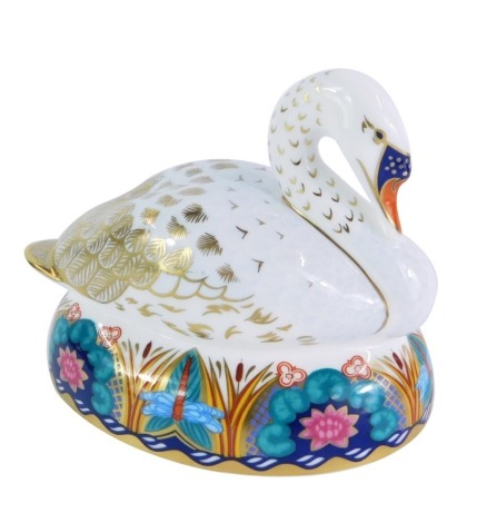A Royal Crown Derby swan paperweight, on elaborately coloured gilt base, with silver stopper, No L1X, 12cm high, boxed.