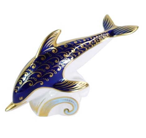 A Royal Crown Derby dolphin paperweight, riding the wave, gold stopper, 18cm wide, boxed.