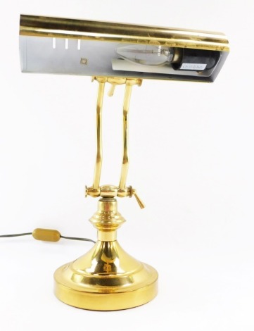 A brass desk lamp, with a domed light top, on anglepoise stem, and circular foot, approx 34cm high when fully extended.