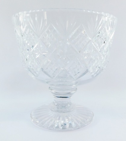 A heavy cut glass fruit bowl, raised on a waisted stem and conical foot, 24cm high, 25cm wide.