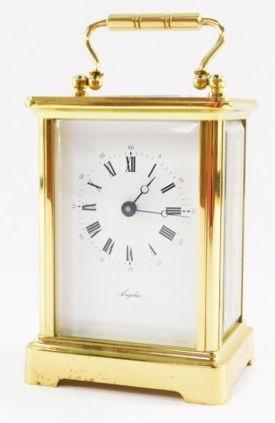 An Angelus brass cased carriage timepiece, rectangular white dial bearing Roman numerals, single barrel dial, the case of conventional form, no key, 12cm high, 8cm wide, 6cm deep.