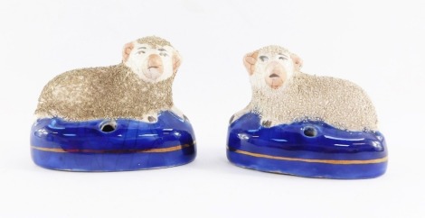 A pair of Staffordshire sheep figures, each with sheep on royal blue base, 7cm high.