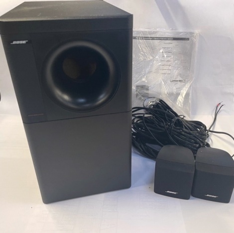 A Bose Acoustic Mass system speaker, 3 Series IV, serial no 024303333510569AC, and two additional smaller speakers, 36cm high.