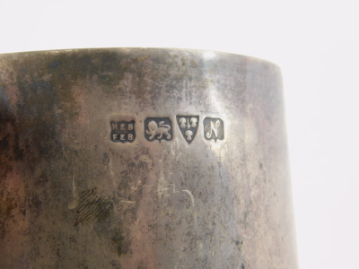 A George V silver mug, of tapering cylindrical form with C shaped handle marked Tombridge Golf Club Lorna G Allies, 1914, Chester 1913, 12cm high and two further silver mugs, 33oz. (3, AF) - 4