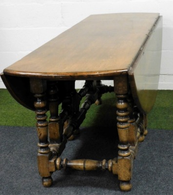 A Jacobean style solid oak and elm wake dining table, with double turned gate leg action, united by turned stretchers, 77cm high, 65cm wide, 160cm extended, 203cm deep. - 2