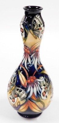 A Moorcroft pottery double gourd shaped vase, decorated with butterflies, flowers, etc., with green marks to underside, 30cm high, boxed. - 2