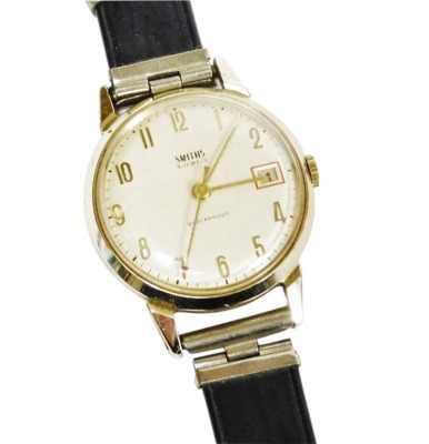 A Smith's gentleman's wristwatch, in gold plated outer surround, on stainless steel back, marked five jewel shock proof, with date aperture, the dial 3cm wide, on a black leather strap.