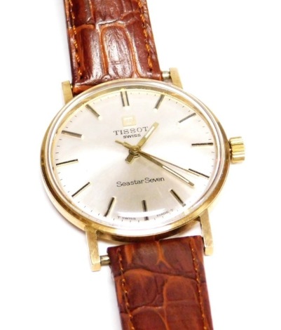 A Tissot Seastar 7 gentleman's wristwatch, with a 9ct gold outer casing, on silvered coloured dial, bearing rear inscription 'Use Key Number 515T' the dial 3cm wide, on a tan leather strap.