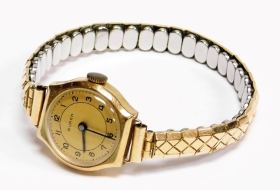 A Buren lady's 9ct gold wristwatch, the circular watch head stamped 375, on an expanding stainless steel and plated bracelet, the dial 2cm wide, in a W Mansell of Lincoln box. - 2